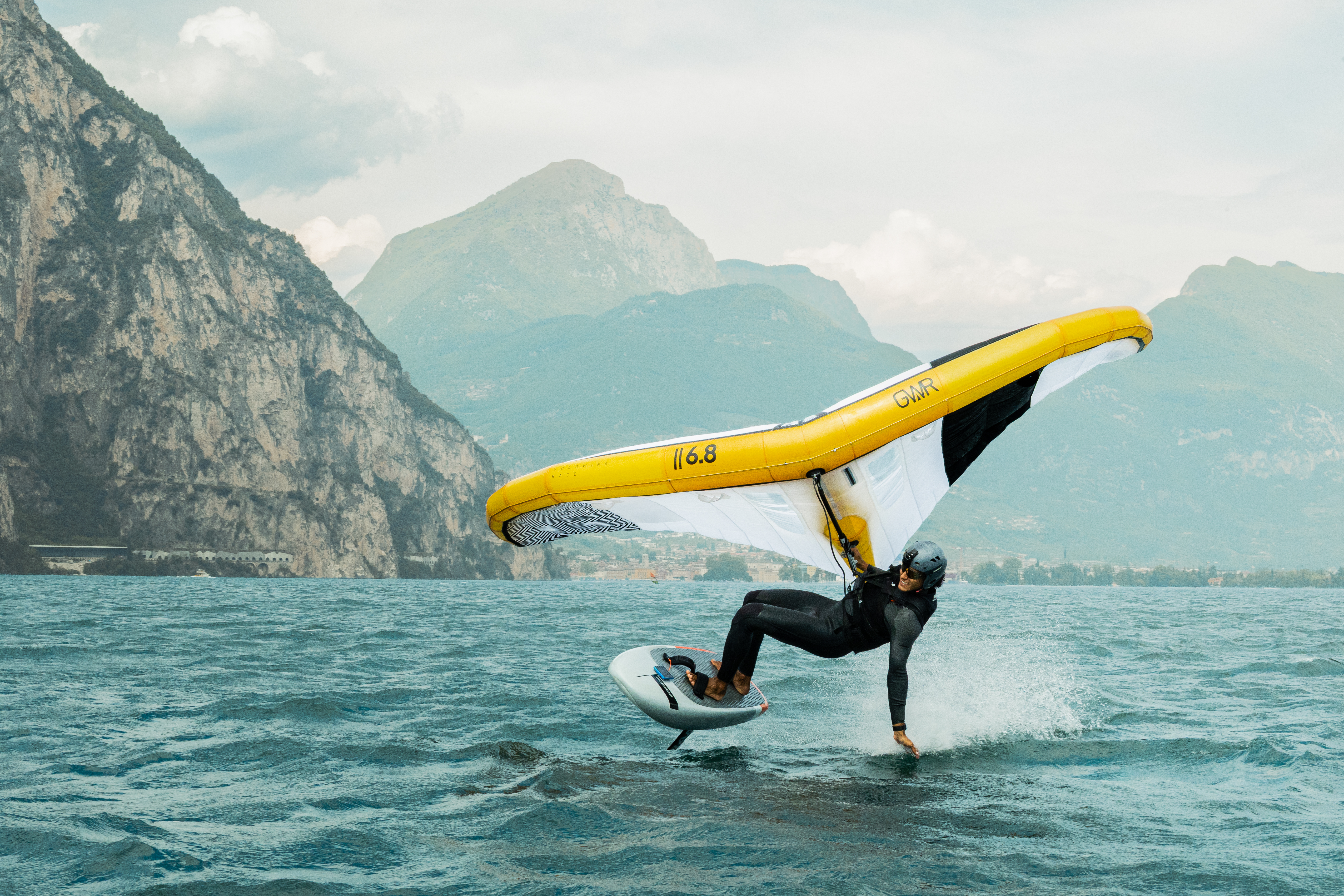 Alessandro racing in full wingfoil equipment on Lake Garda